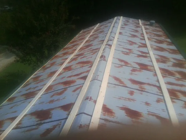 Rusted metal roof panels with new wood purlins before replacement — Storm Damage Roof Repair in Amissville by Roofing Brothers